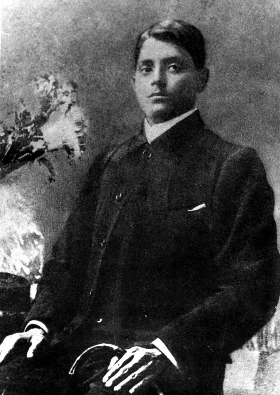 Seated studio portrait of Jatindranath Mukherjee in a dark coat.